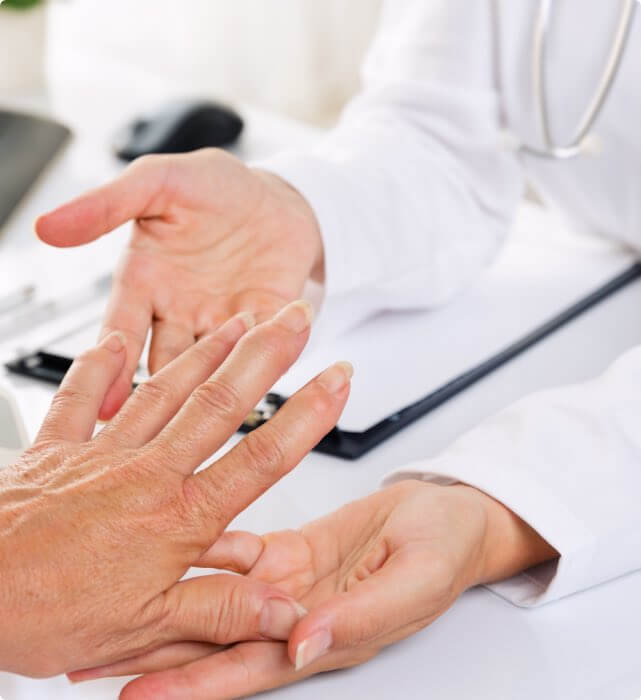 Image of doctor inspecting patient's hand